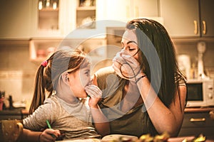 Mommy make me laughing. Little girl spending time with mother.