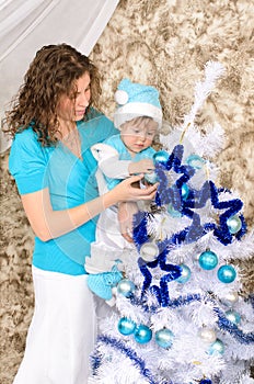 Mommy and son adorning christmas tree