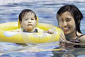 Mommy swimming together with her baby