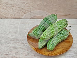 Momordica charantia bitter melon fruit on the wooden table photo