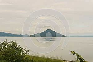 Momotombo and Momotombito volcanoes across Lake Managua photo