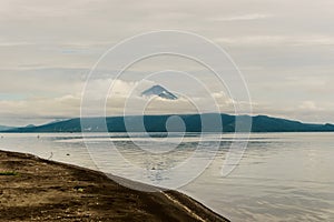 Momotombo and Momotombito volcanoes across Lake Managua photo