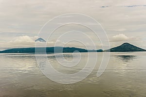 Momotombo and Momotombito volcanoes across Lake Managua photo