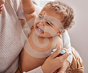 Moms always got you. a baby crying while having her temperature checked by her mother.