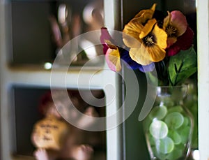 Moms nicknack shelf with flowers and ceramic animals