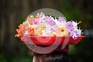 Mon girl carry flowers on head