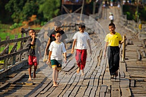 Mon refugee kids cross saphan mon wooden bridge