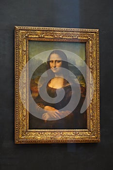The Mona Lisa original painting on display in the Louvre Museum. The Mona Lisa is a half-length portrait painting by Italian artis