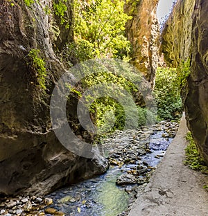 The Monachil river flows exits a tunnel into a gorge in the Sierra Nevada mountains, Spain