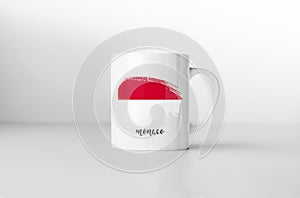 Monaco flag on white coffee mug.