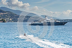 Monaco, Monte-Carlo, most expensive mega yacht on sea, sunny day, Jet Ski, mountains on background