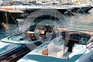 Monaco, Monte Carlo, 28 September 2022 - Riva boats in a row and a lot of luxury mega yachts at the famous motorboat