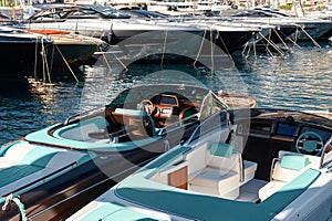 Monaco, Monte Carlo, 28 September 2022 - Riva boats in a row and a lot of luxury mega yachts at the famous motorboat