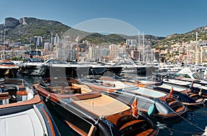 Monaco, Monte Carlo, 28 September 2022 - Riva boats in a row and a lot of luxury mega yachts at the famous motorboat