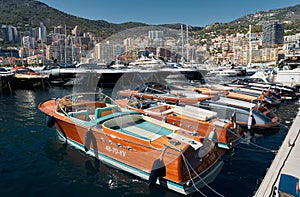 Monaco, Monte Carlo, 28 September 2022 - Riva boats in a row and a lot of luxury mega yachts at the famous motorboat