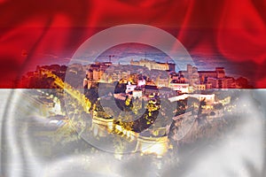 Monaco. Prince palace and old town on the hill in Monaco on Monegian flag overlay view