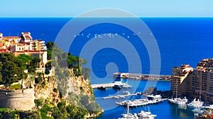 Monaco`s Rocher and the Fontvieille marina with Regatta in background photo