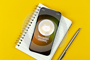 Monacoin symbol. Trade with cryptocurrency, digital and virtual money, banking with mobile phone concept. Business