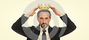 Monarchy family traditions. Man nature bearded guy in suit hold golden crown symbol of monarchy. Direct line to throne