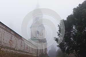 Monastery Bell Tower Vanishing in Autumn Morning Mist