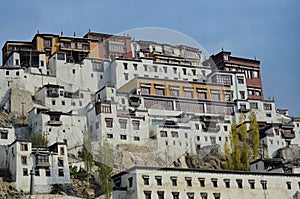 The monastery buildings of Thiksey Gompa in Ladakh, India against a blue sky.