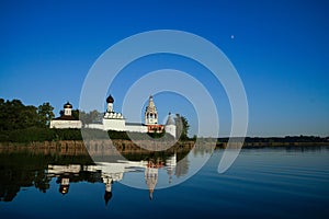 Monastery on the island with reflection in the smooth water of the lake