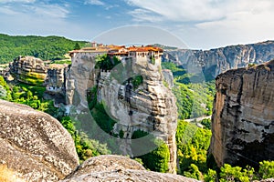 Monastery Meteora Greece. Stunning summer panoramic landscape. View at mountains and green forest against epic blue sky with