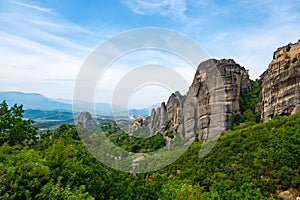 Monastery Meteora Greece. Stunning summer panoramic landscape. View at mountains and green forest against epic blue sky with