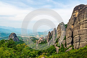 Monastery Meteora Greece. Stunning summer panoramic landscape. View at mountains and green forest against epic blue sky with