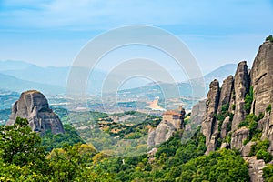 Monastery Meteora Greece. Stunning summer panoramic landscape. View at mountains and green forest against epic blue sky with