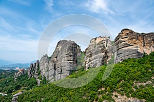 Monastery Meteora Greece. Stunning summer panoramic landscape. View at mountains and green forest against epic blue sky with