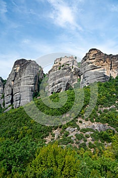 Monastery Meteora Greece. Stunning summer panoramic landscape. View at mountains and green forest against epic blue sky with