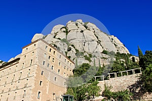 A monastery on Mount Montserrat near Barcelona in the photo of a bright blue sky. photo