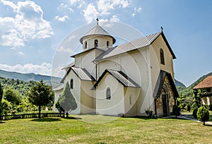 Monastery on the river Moraca amid mountains in the background.