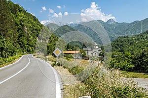 Monastery on the river Moraca amid mountains in the background.