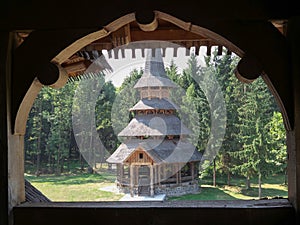 Monastery Sapanta-Peri in Maramures, Romania photographed through a sclupted window