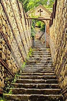 Monastery of St. Nino at Bodbe, Georgia. Stone stairs and stone arch after rain