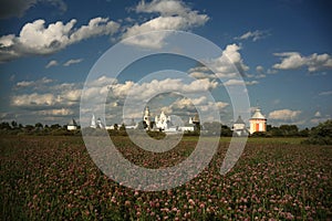 Monastery among summer sunny field