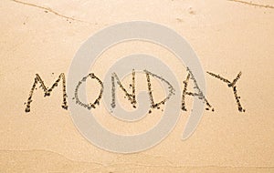 Monday - written in sand on beach texture, days week series