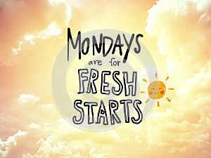 Mondays are for fresh starts word lettering and sun smile on golden sky