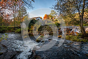 Mondim de Basto waterfall with a mill house at sunset in Portugal