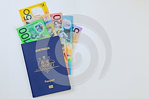 Money Australian currency dollars cash banknotes in Australian passport on a white background