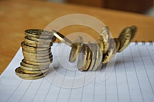 Money background of falling pile of coins as a symbol of financial deterioration photo