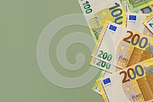 Money background. One and two hundred euro banknotes on a green background.Money and finance.Finance and savings.
