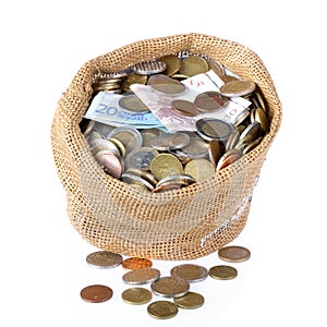 Money bag with coins and banknotes isolated over white