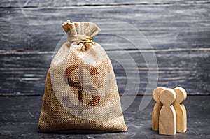 Money bag with a dollar sign and people figurines. concept of attracting investment, business cooperation, crowdfunding