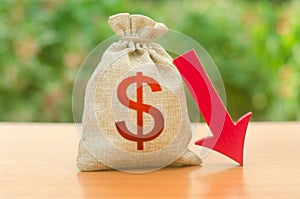 Money bag with dollar symbol and red arrow down. Reduced tax revenues, economic difficulties, departure of capital, investors.