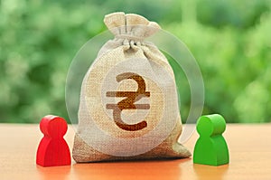 Money bag with money ukrainian hryvnia symbol and two people figures. Business Investment and lending, leasing. Business