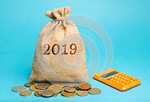 Money bag with the word 2019 and a calculator. Business Financial Reporting Concept. Evaluation of the financial position. Audit.