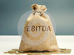 Money bag with the word Ebitda. Earnings before interest, taxes, depreciation and amortization. Financial result of the company.